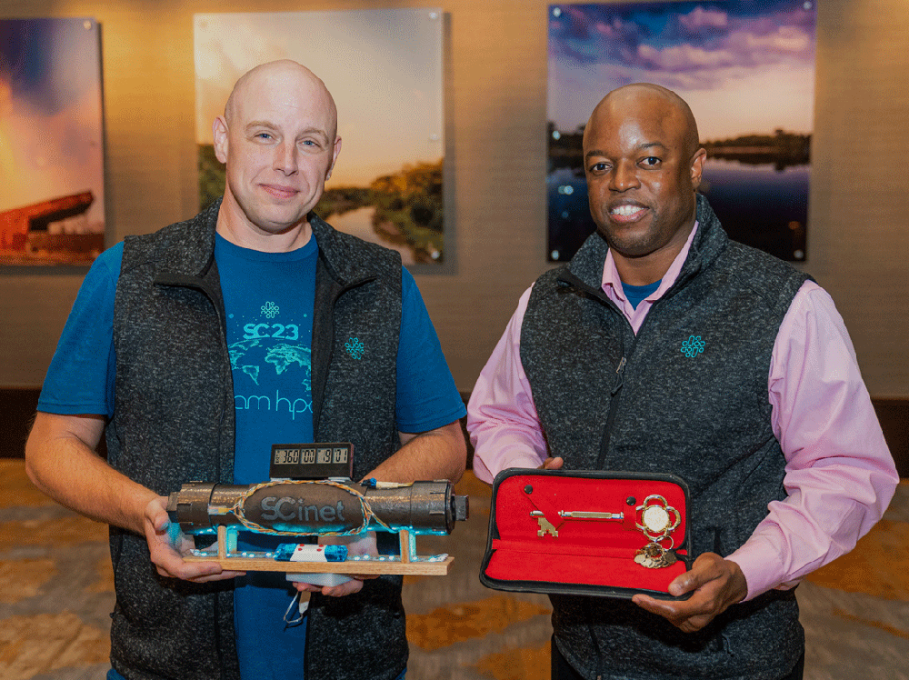 Hans Addleman and Dorian C. Arnold holding the proverbial keys to the SC23 conference.