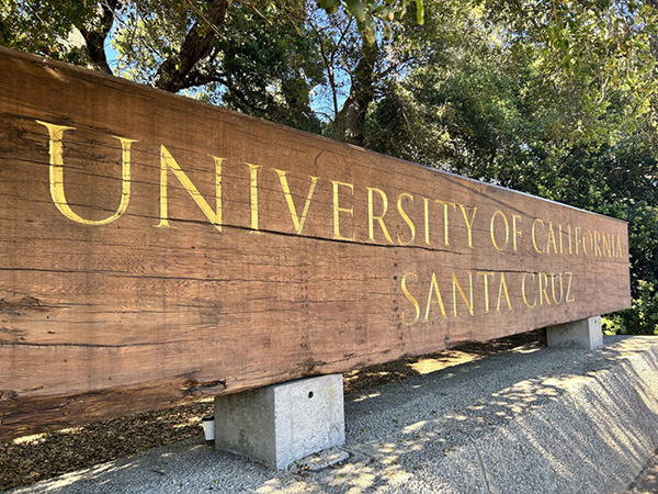 Wooden monument sign that says University of California Santa Cruz