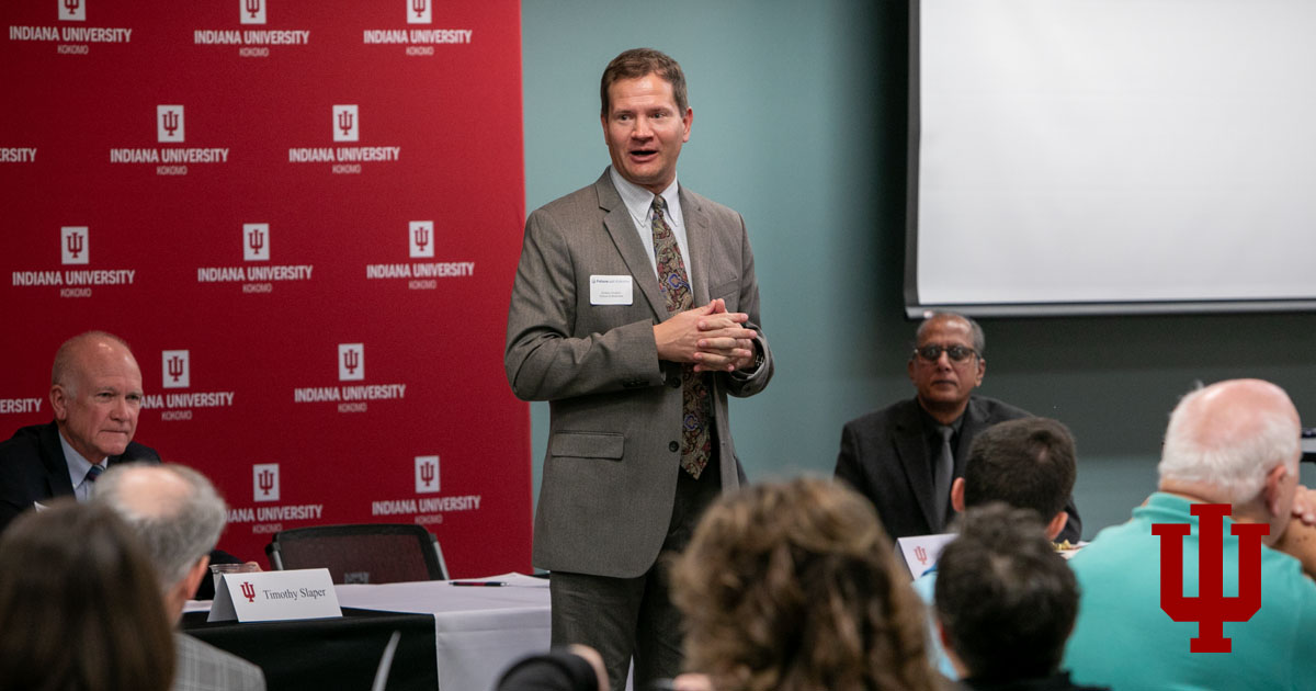 A man speaks in a suit