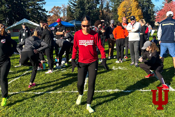 A woman in a red shirt at the starting line of a race