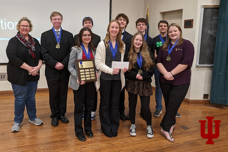 A group of teenagers holding certificates