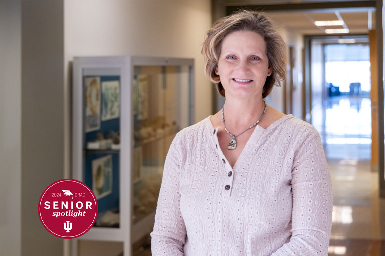 A woman stands in a hallway