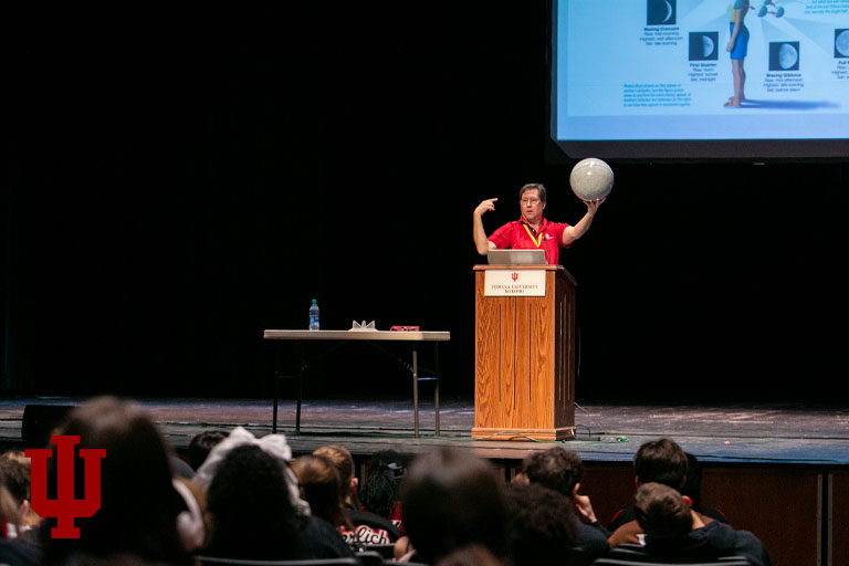 A man stands on a stage at a podium