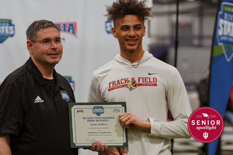 Two men with an award certificate