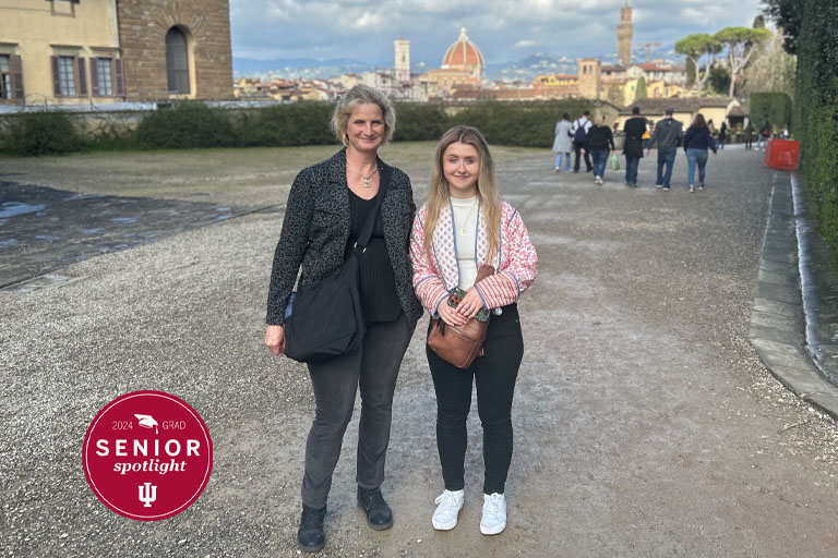 Two women stand in front of a church in Italy