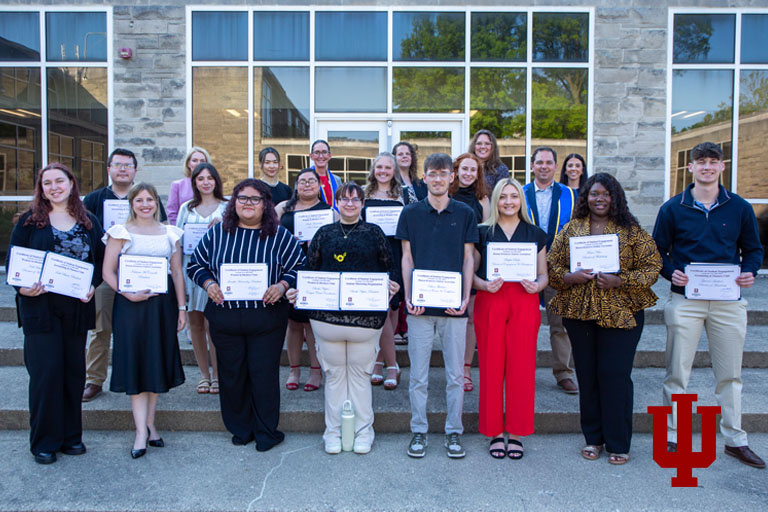 A group of people holding certificates