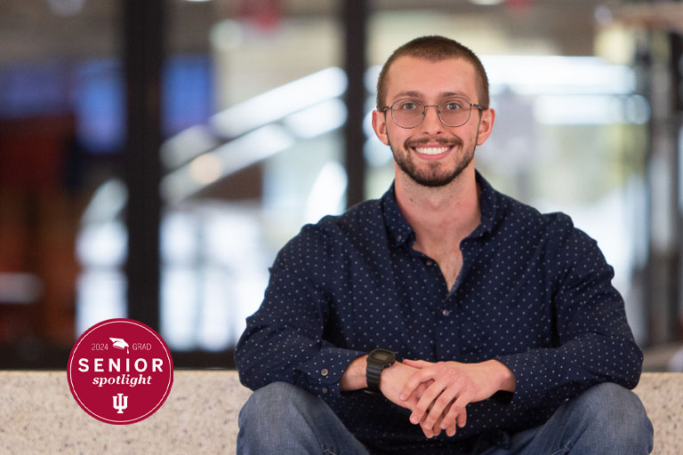 A man poses for a picture on steps