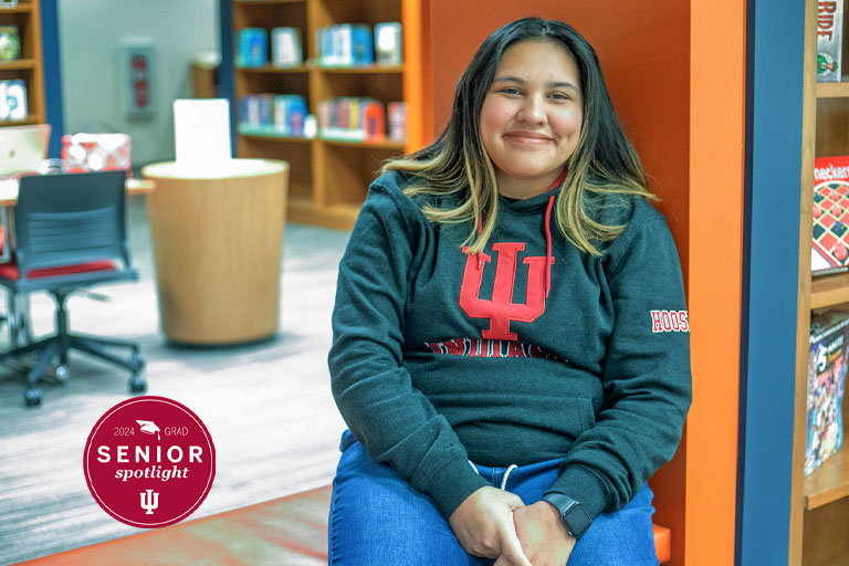 A woman poses in a library