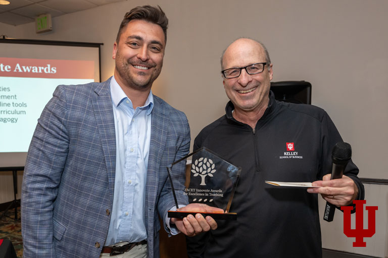 Two men with an award certificate