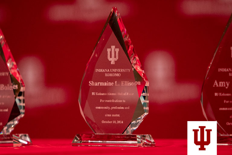 a glass award against a red background