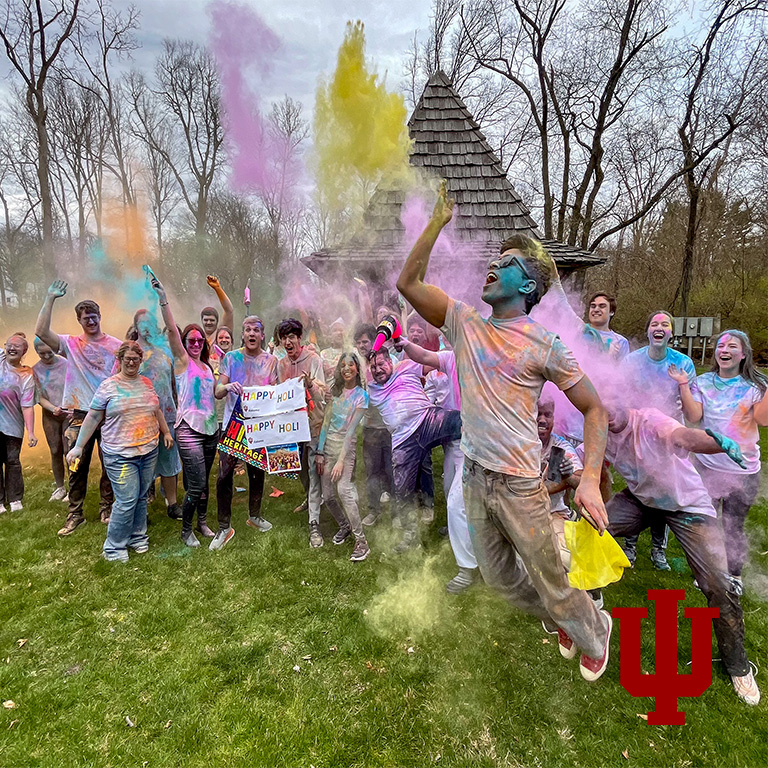 A group picture of people with colored powder