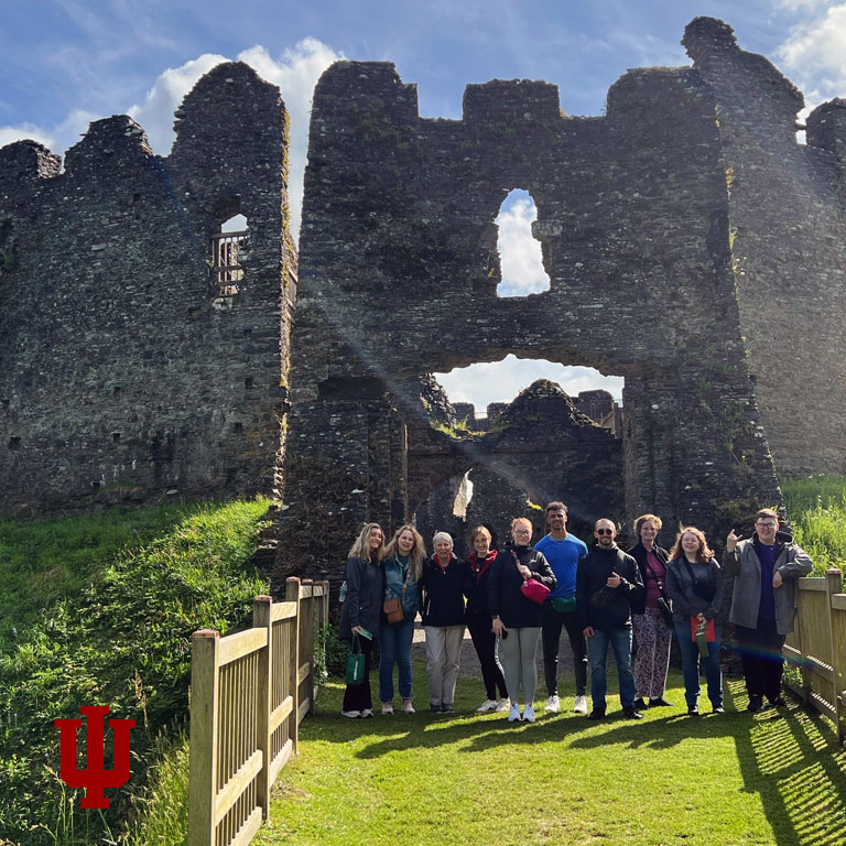A group of students pose in front of a castle