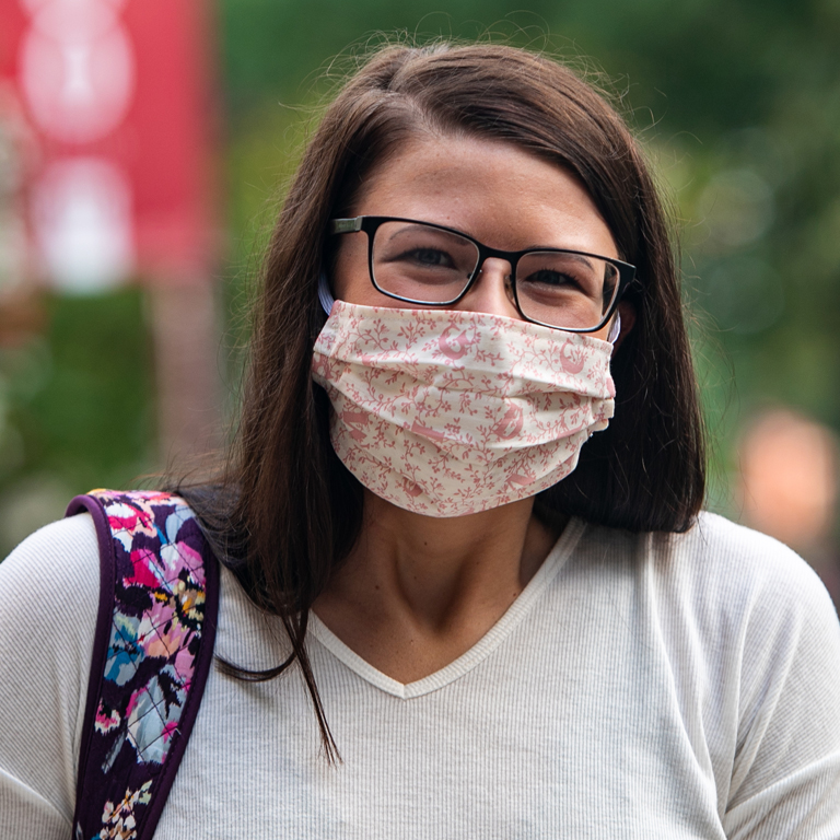 A woman wears a cloth mask