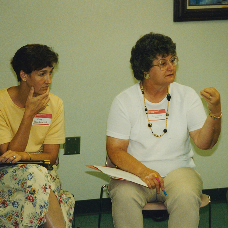 Two women participate in a discussion