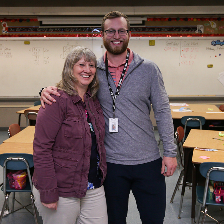 A woman and a man in an elementary classroom