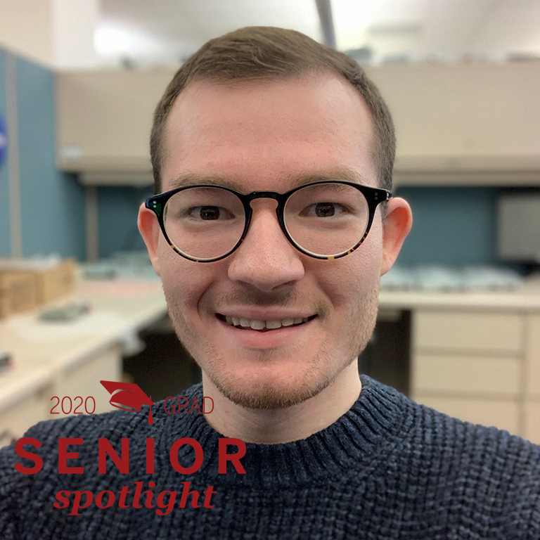 A man wearing glasses smiles for a picture