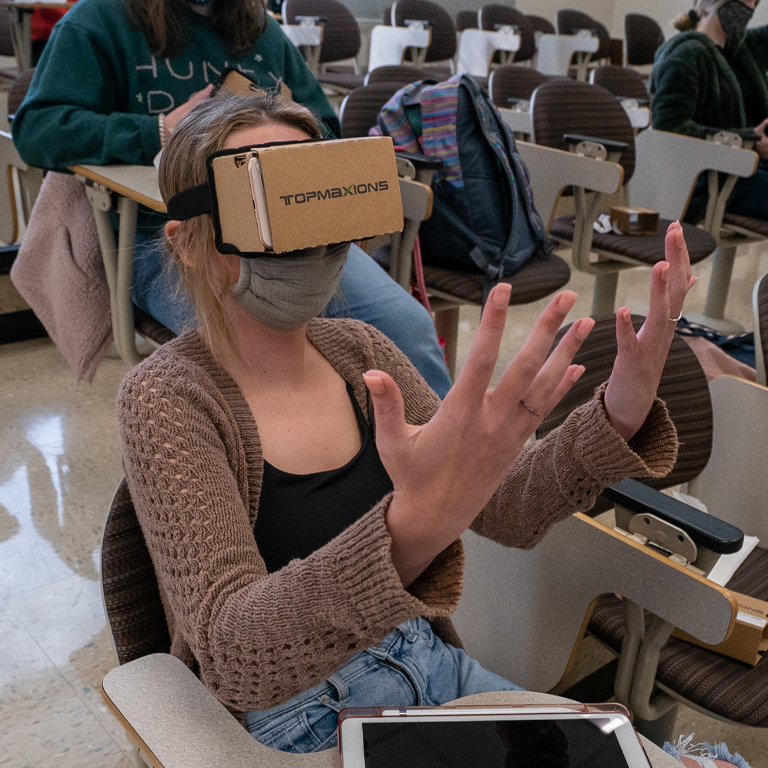 A woman with virtual reality goggles on her face
