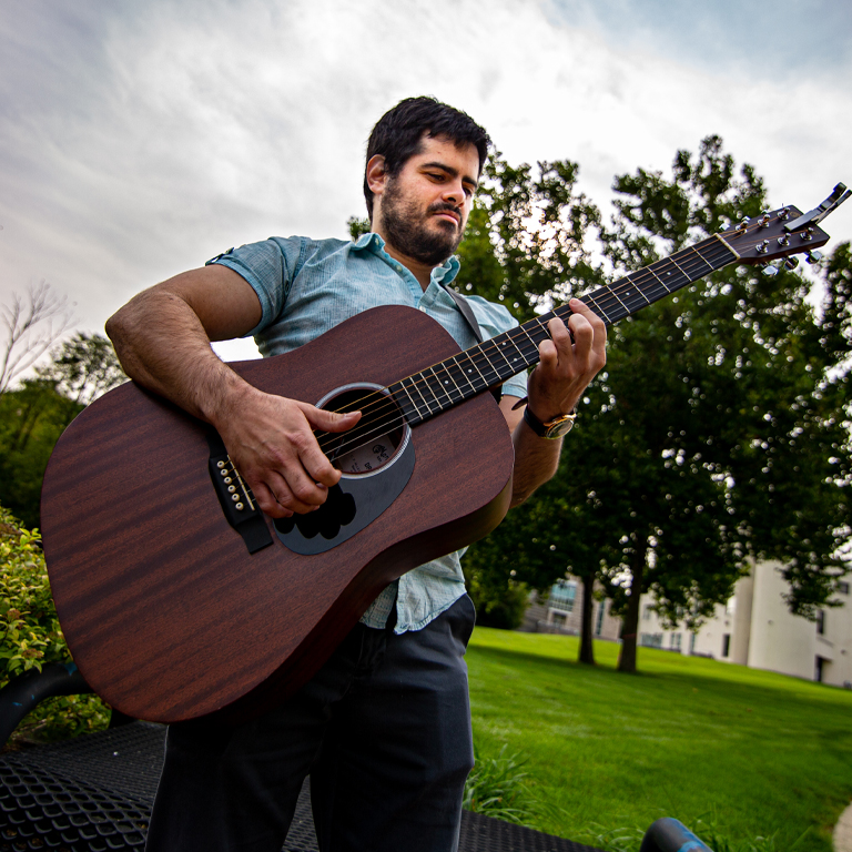A man plays a guitar