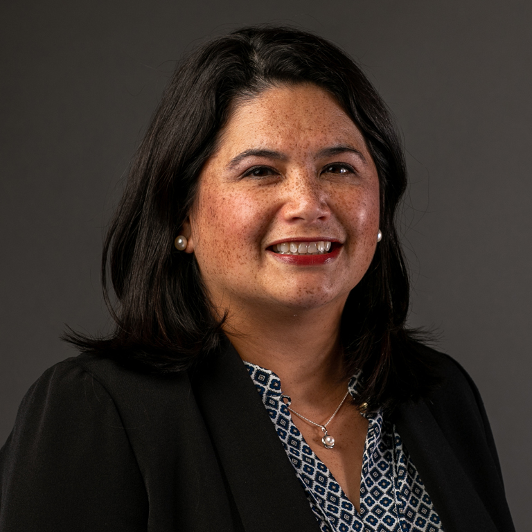 A portrait of a woman in a blue suit