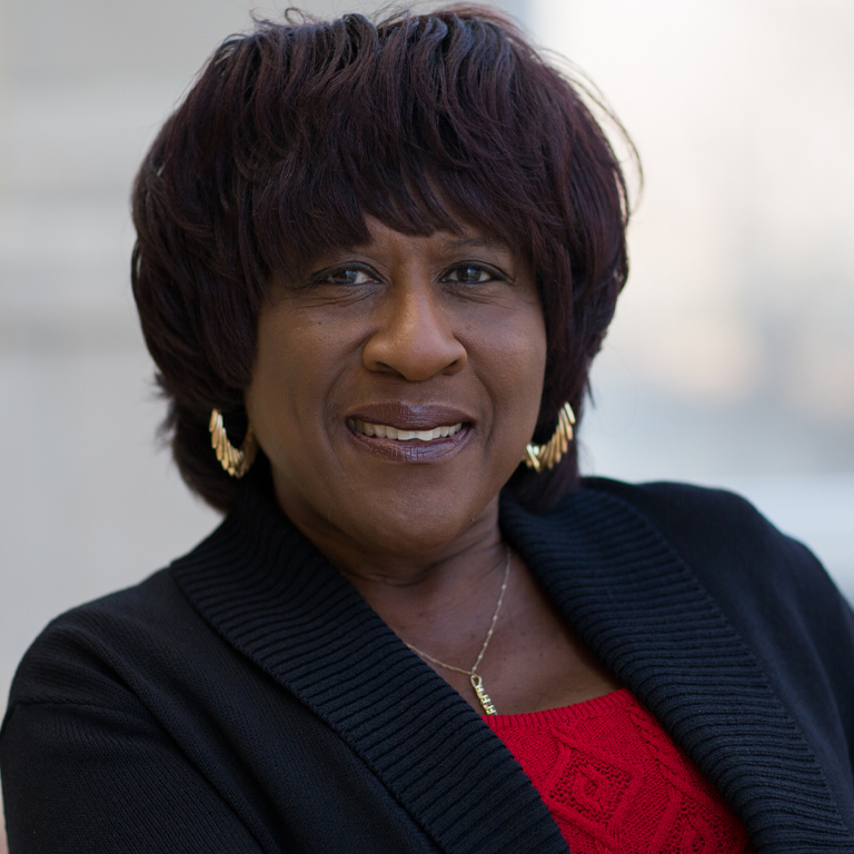 A woman smiles for a portrait