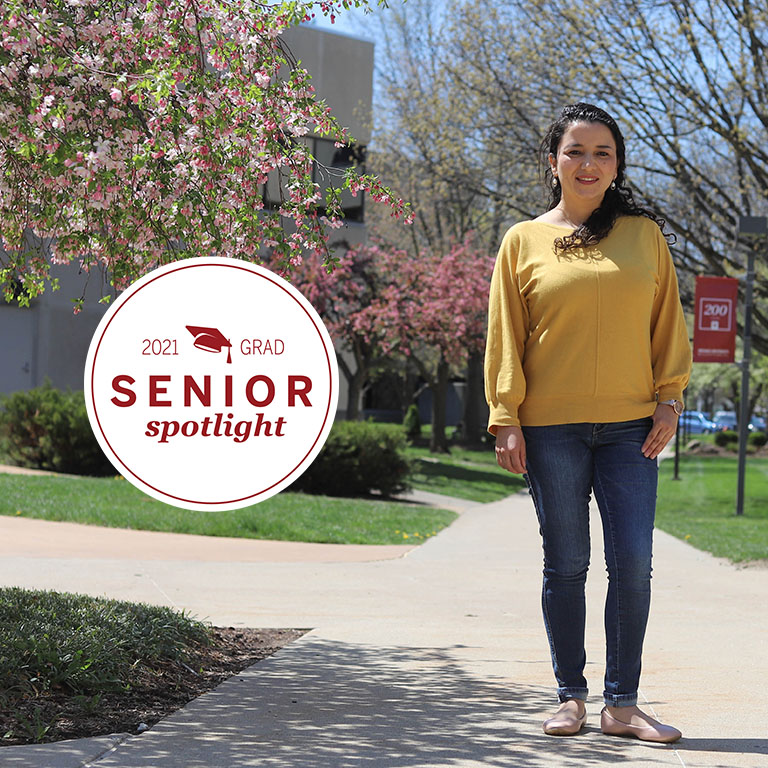 A woman stands in the quad
