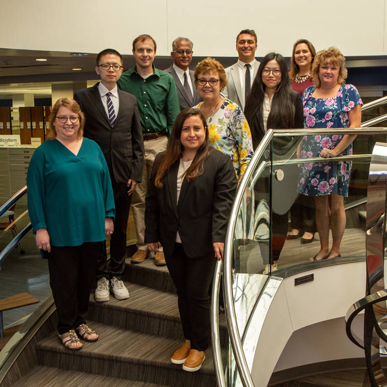 A group of people stand on stairs