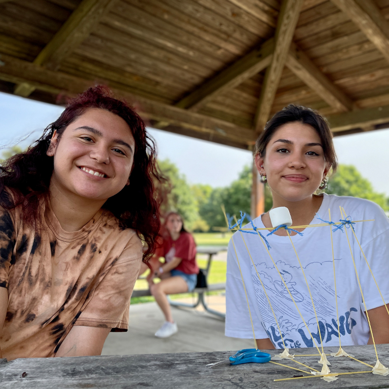 Two women at a picnic table
