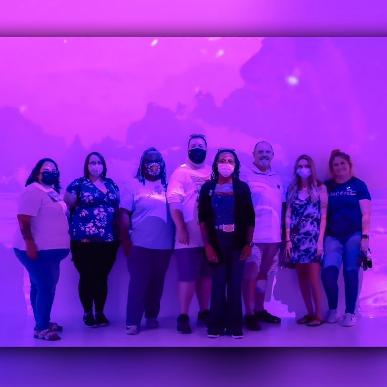 Group picture in front of a purple screen