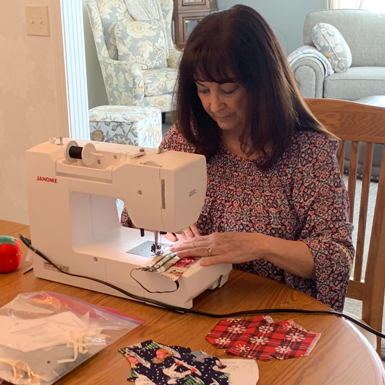 A woman works at a sewing machine