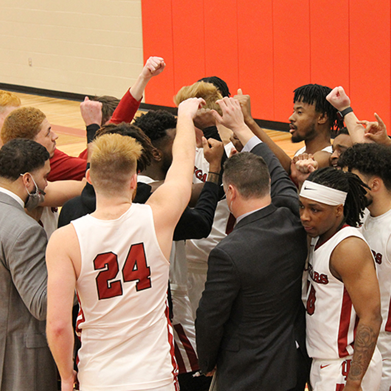 A basketball team in a huddle