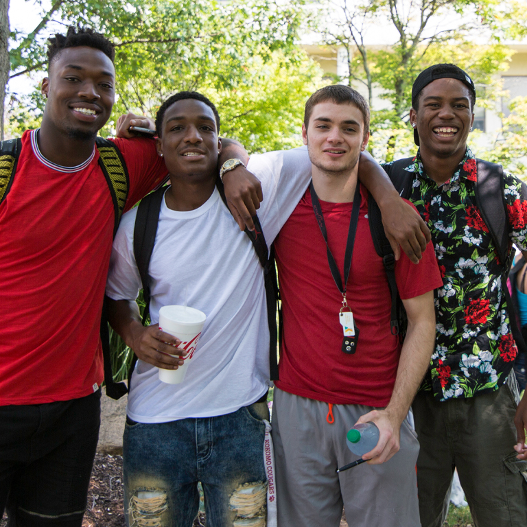 Four men pose for a picture
