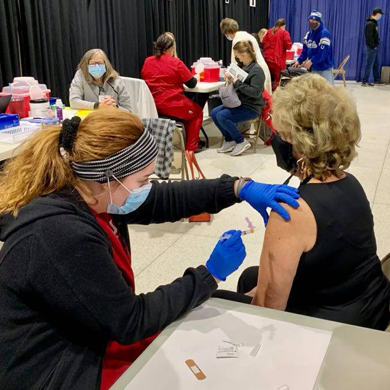 A woman gives a vaccination
