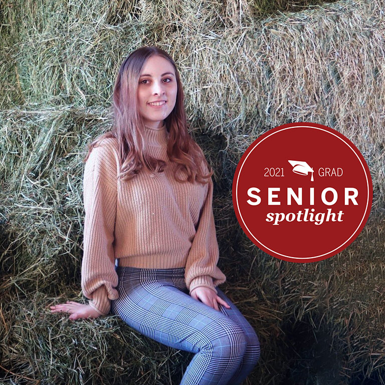 A woman by hay bales