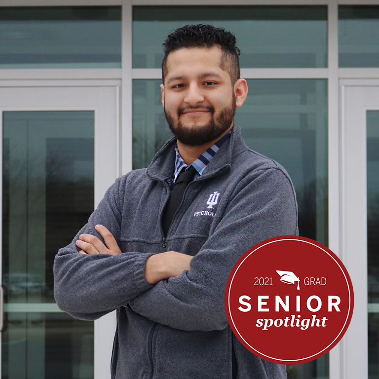 A man stands in front of a building