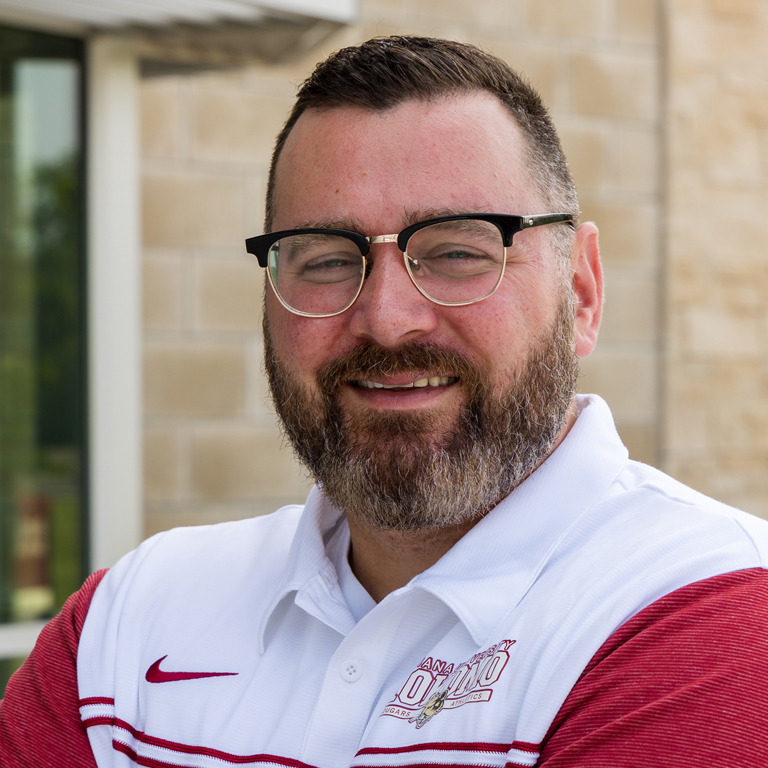 A man in a red and white polo
