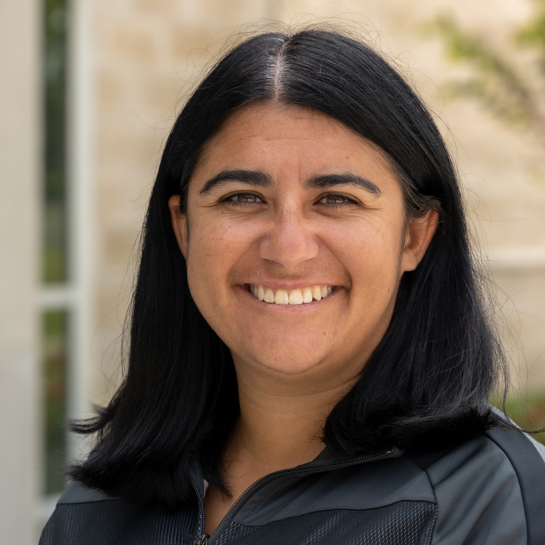 a woman smiles for a picture