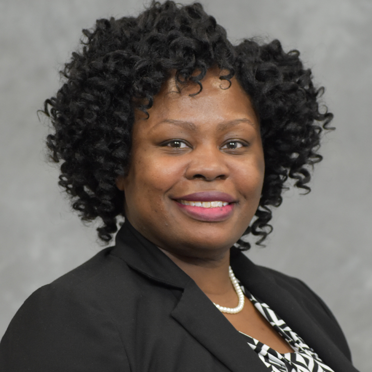 A woman smiles for a picture