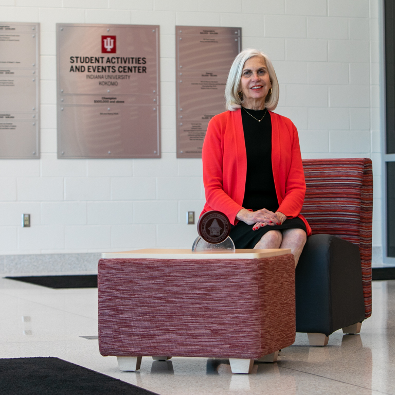 A woman sits on a chair