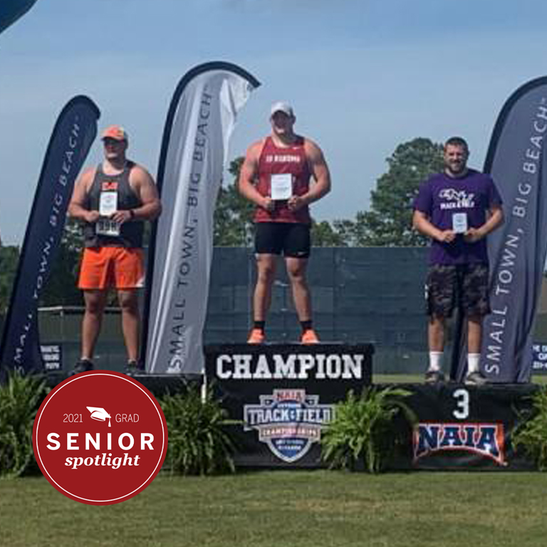 Three athletes on an awards podium