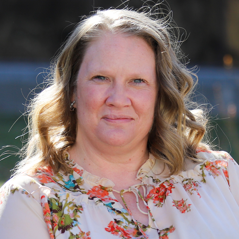 A woman smiles for a picture