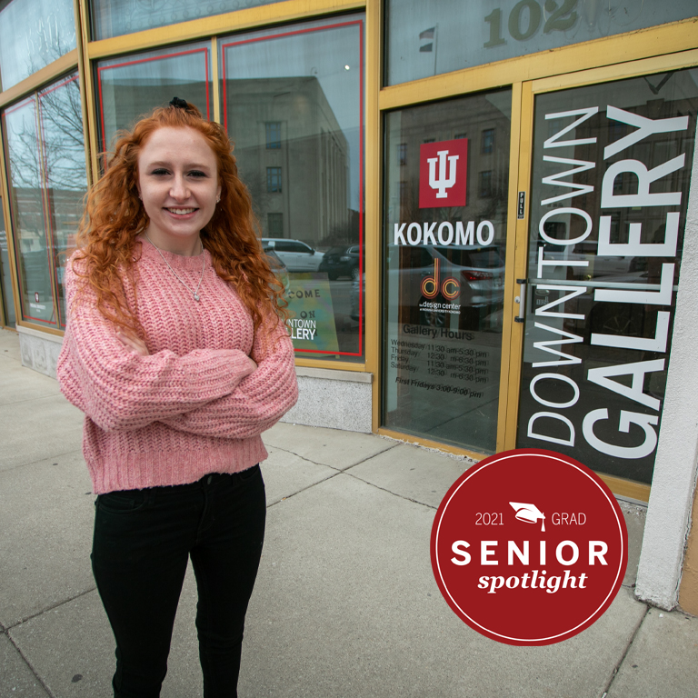 A woman stands outside an art gallery