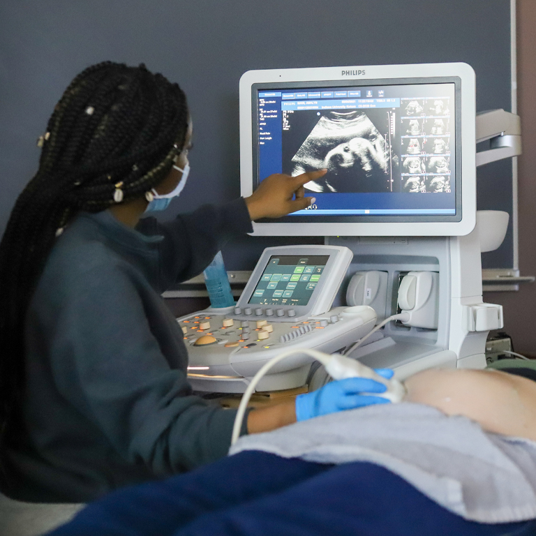 A woman looks at an ultrasound image