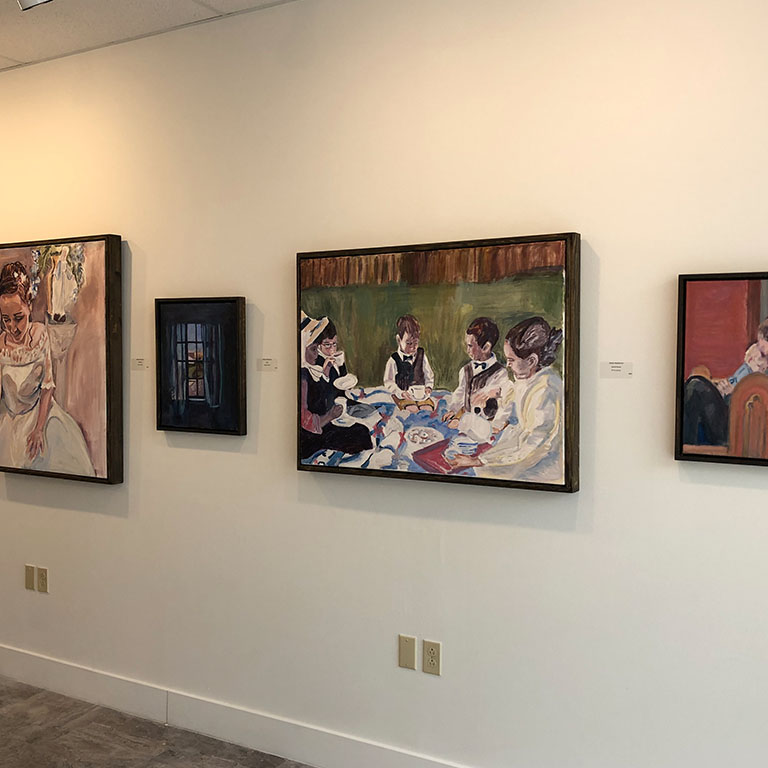 Four framed artworks on a wall