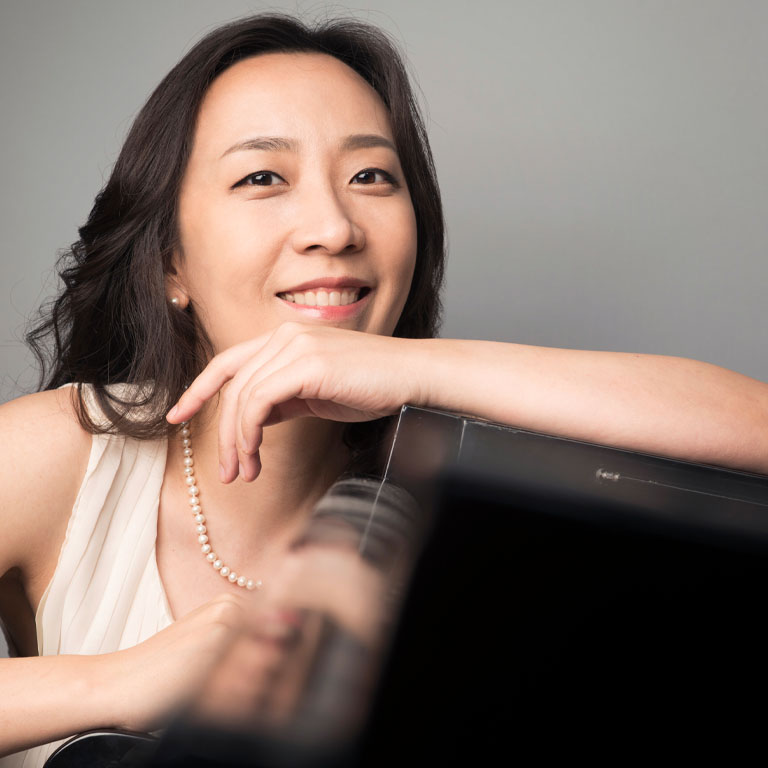 a woman with a piano