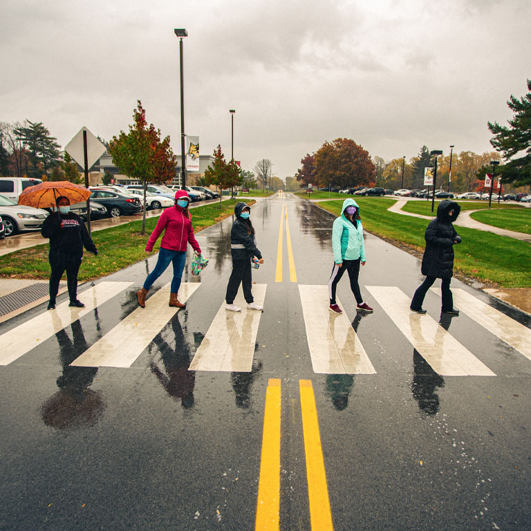 Five students in a crosswalk