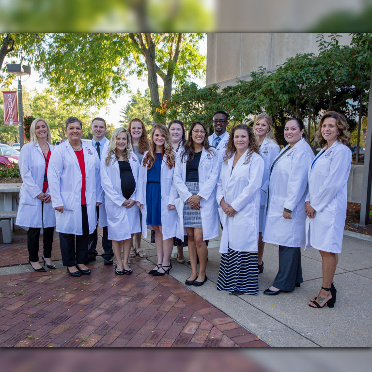 13 people in white medical coats