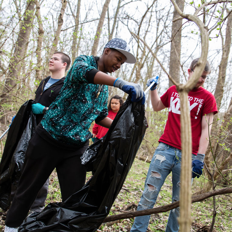 A group of people pick up trash