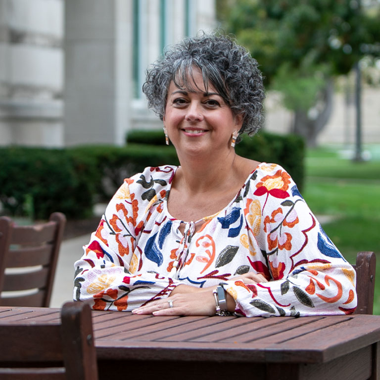 A woman smiles for a portrait