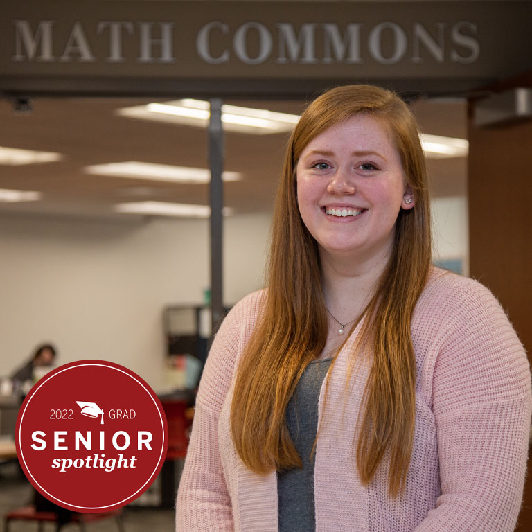 A woman stands at the entrance to the math commons