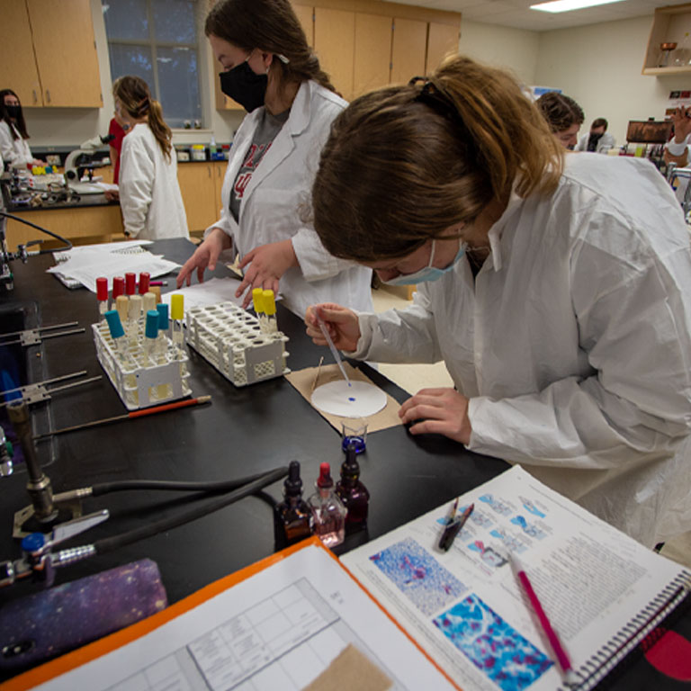 Two women work in a lab
